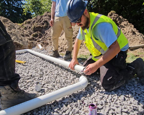 Contractor handling pipe repair as part of septic maintenance service